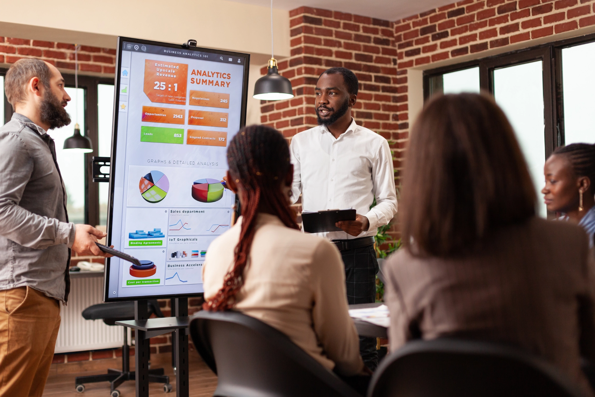 man standing behind flat screen computer monitor