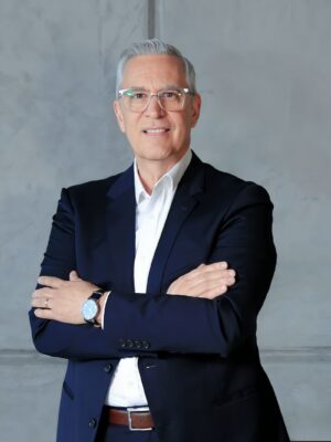 a man in a suit standing with his arms crossed